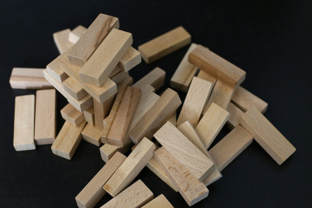 pieces of jenga tower in disarray to symbolise risky investment that benefits from an MOU beforehand